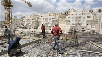 Des travailleurs érigent un complexe d'habitation à Jérusalem-Est. Des travailleurs érigent un complexe d'habitation à Jérusalem-Est.