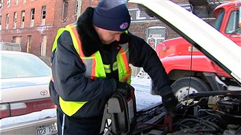 Un technicien du CAA procède au survoltage d'une voiture. Un technicien du CAA procède au survoltage d'une voiture.