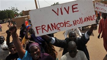 Des Maliens brandissent des pancartes remerciant le président français, à Ansongo, proche de la frontière avec le Niger. Des Maliens brandissent des pancartes remerciant le président français, à Ansongo, proche de la frontière avec le Niger.