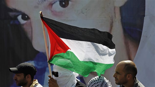 Des Palestiniens devant une affiche montrant l'adolescent Mohamed Abou Khoudaïr, le 4 juillet 2014 Des Palestiniens devant une affiche montrant l'adolescent Mohamed Abou Khoudaïr, le 4 juillet 2014