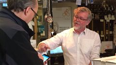 Richard Harvey, le propriétaire de la boutique Metrovino, conseille un client. Richard Harvey, le propriétaire de la boutique Metrovino, conseille un client.