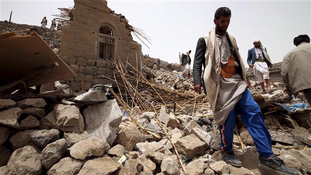 Des résidents sur les décombres de maisons détruites par une frappe aérienne dans un village près de Sanaa. Des résidents sur les décombres de maisons détruites par une frappe aérienne dans un village près de Sanaa.