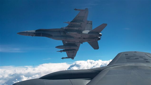 A Royal Canadian Air Force CF-18 Hornet breaks away after refueling with a KC-135 Stratotanker assigned to the 340th Expeditionary Air Refueling Squadron, Thursday, Oct. 30, 2014 over Iraq. A Royal Canadian Air Force CF-18 Hornet breaks away after refueling with a KC-135 Stratotanker assigned to the 340th Expeditionary Air Refueling Squadron, Thursday, Oct. 30, 2014 over Iraq.