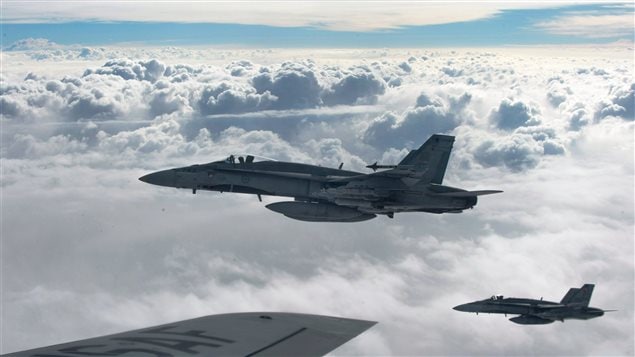 Royal Canadian Air Force CF-18 Hornets depart after refueling with a KC-135 Stratotanker assigned to the 340th Expeditionary Air Refueling Squadron, October 30, 2014, over Iraq. Royal Canadian Air Force CF-18 Hornets depart after refueling with a KC-135 Stratotanker assigned to the 340th Expeditionary Air Refueling Squadron, October 30, 2014, over Iraq.