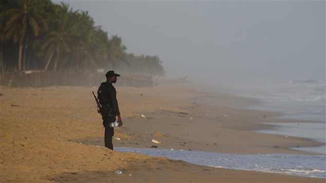 Un membre des forces de sécurité ivoiriennes fait le guet sur la plage, à la suite d'une fusillade à Grand-Bassam, en Côte d'Ivoire. Un membre des forces de sécurité ivoiriennes fait le guet sur la plage, à la suite d'une fusillade à Grand-Bassam, en Côte d'Ivoire.