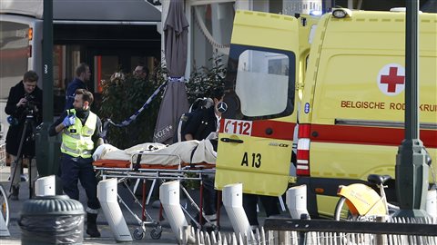 Une victime de la fusillade survenue au cours d'une perquisition à Bruxelles est évacuée en ambulance. Une victime de la fusillade survenue au cours d'une perquisition à Bruxelles est évacuée en ambulance.