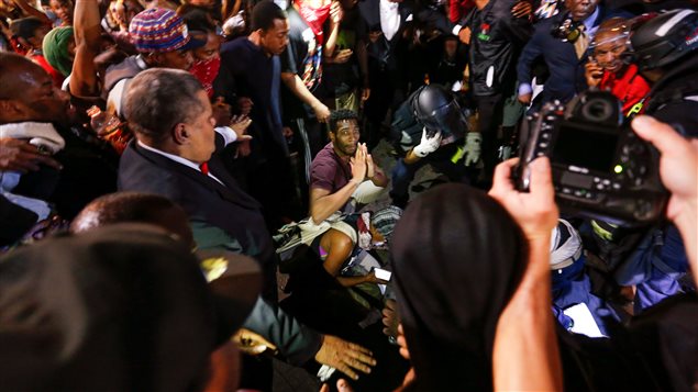 Des gens encerclent une personne blessée à la suite d'une altercation. Des gens encerclent une personne blessée à la suite d'une altercation.