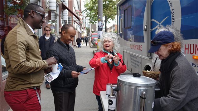 Des bénévoles de la Société Saint-Vincent-de-Paul distribuent café et biscuits aux passants Des bénévoles de la Société Saint-Vincent-de-Paul distribuent café et biscuits aux passants