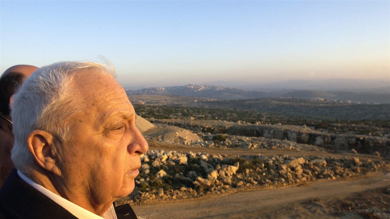 (8 janvier 2003) Une photo livrée par Israël montre le premier ministre jetant un regard sur la « ligne verte », qui définit les territoires palestiniens et israéliens depuis le cessez-le-feu de 1967. (8 janvier 2003) Une photo livrée par Israël montre le premier ministre jetant un regard sur la « ligne verte », qui définit les territoires palestiniens et israéliens depuis le cessez-le-feu de 1967.