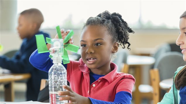 Une jeune fille bricole avec des matériaux recyclés. Une jeune fille bricole avec des matériaux recyclés.